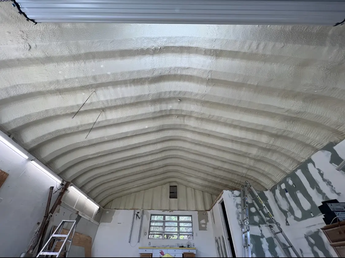 Spray polyurethane foam applied to the underside of a metal roof deck in Milford